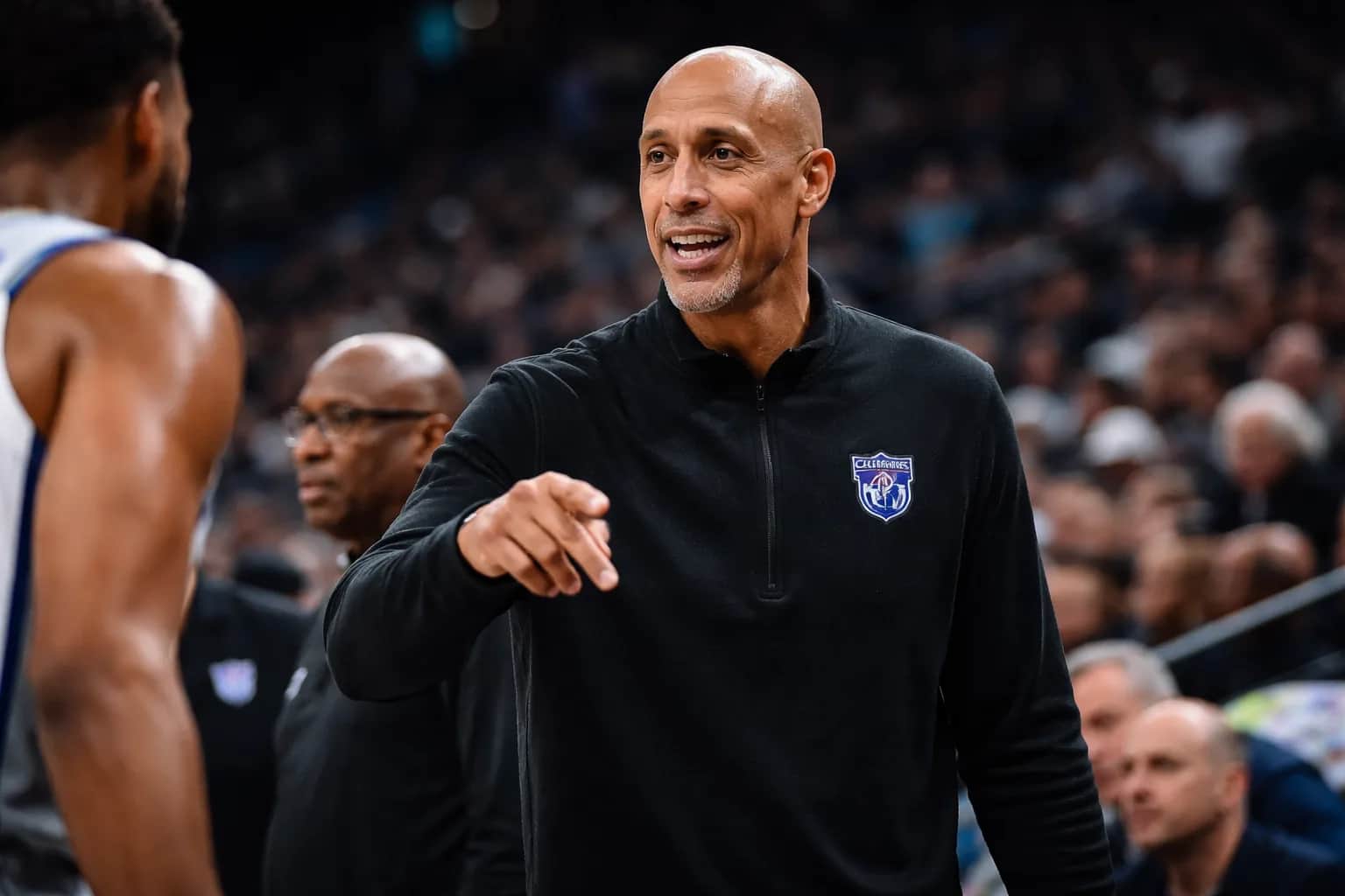 Doug Christie stands on the sidelines during a Sacramento Kings game, gesturing to players.