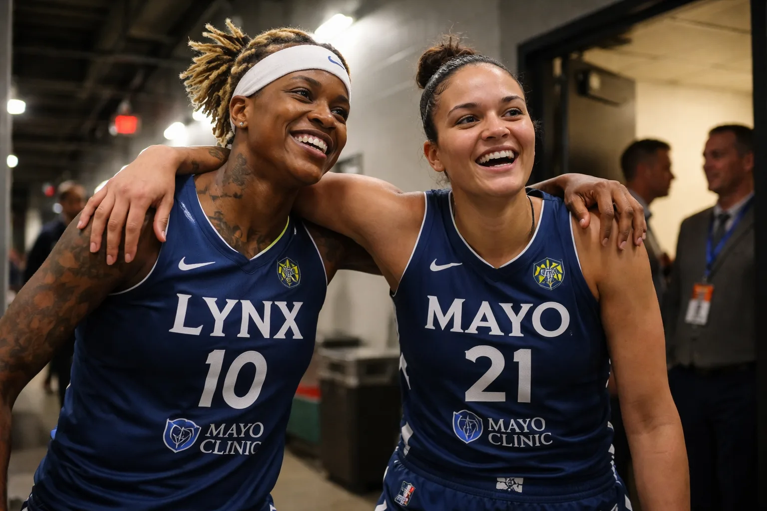 Courtney Williams and Kayla McBride celebrating on the court in Minnesota Lynx jerseys