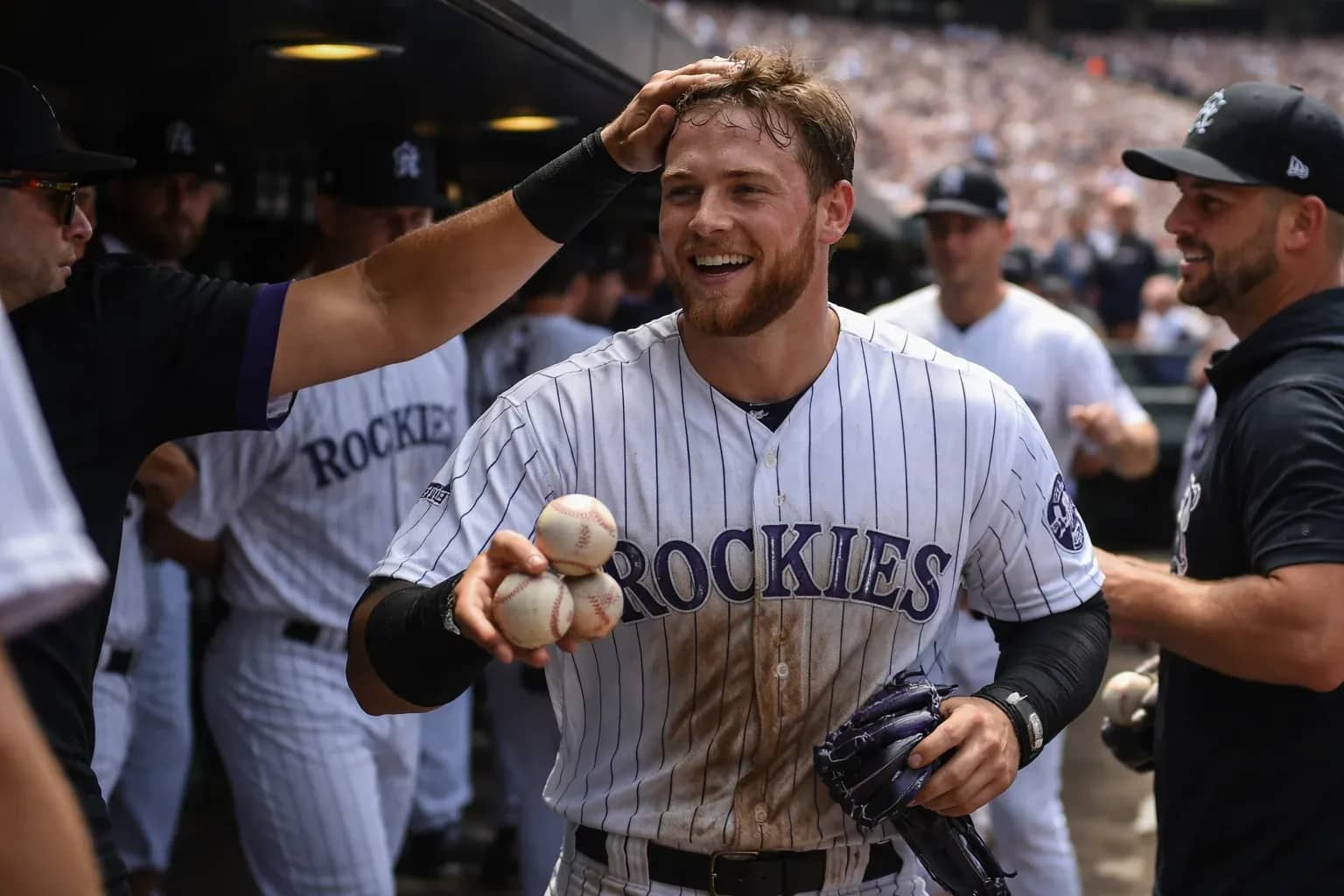 Colorado Rockies catcher Hunter Goodman completes a swing during his three-home run game performance.