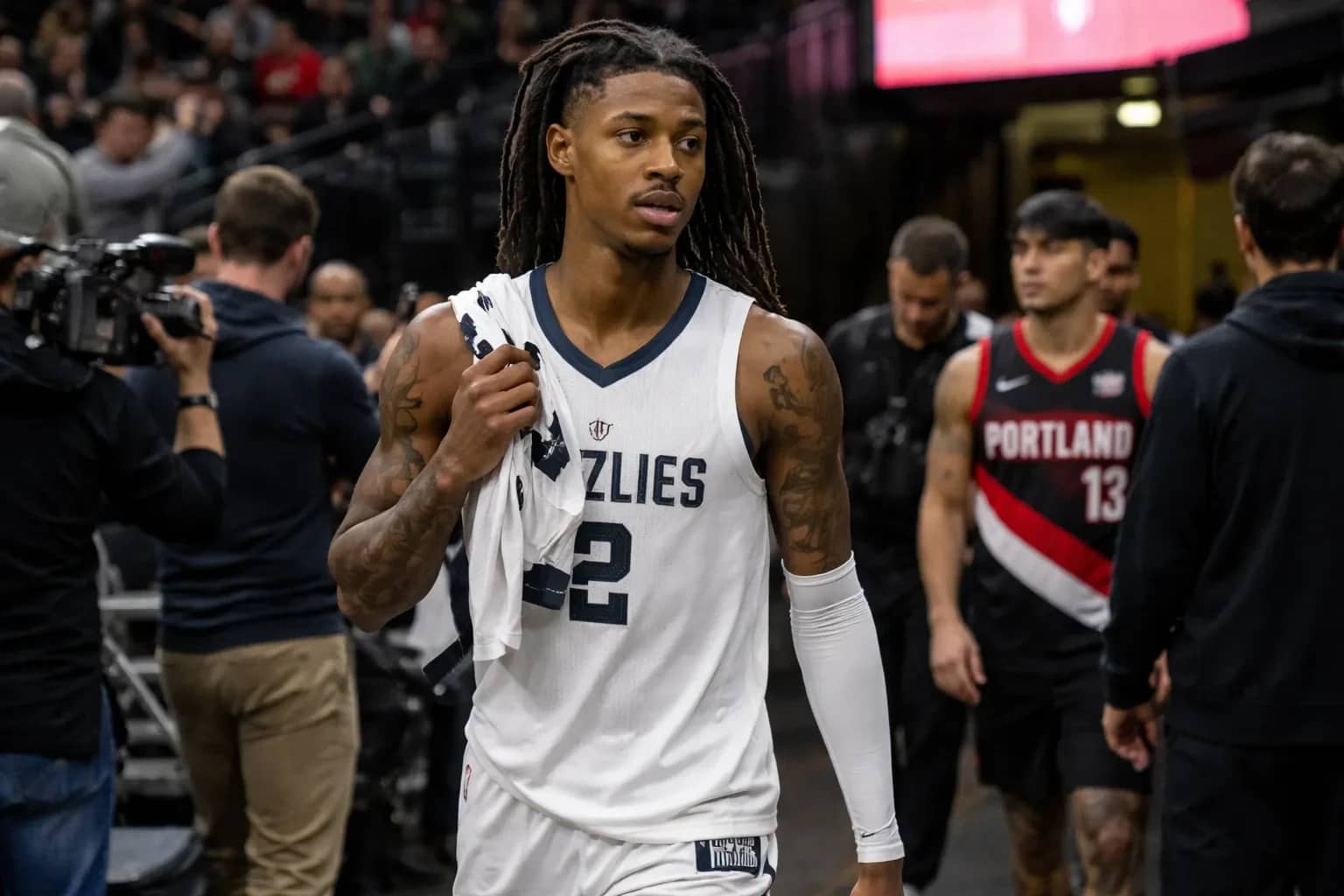 Ja Morant driving to the basket in a Memphis Grizzlies jersey before being traded to the Portland Trail Blazers.