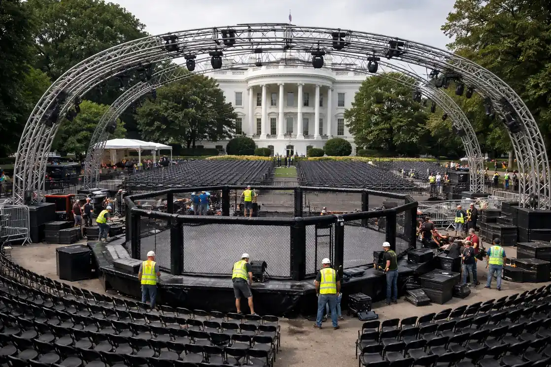 Workers assembling a UFC octagon cage on the South Lawn of the White House.